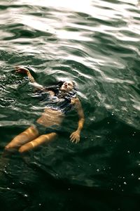 High angle view of woman swimming in lake