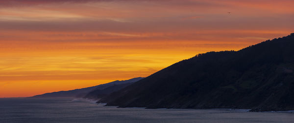 Scenic view of sea against orange sky