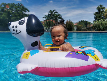 Portrait of happy babygirl in swimming pool