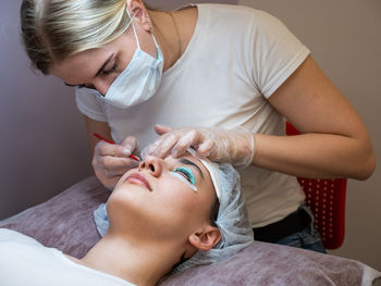 Midsection of doctor examining patient at spa