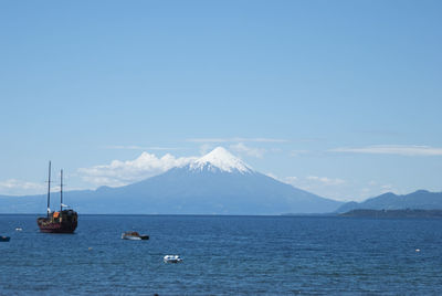 Sea with mountain in background