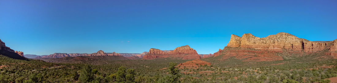 Scenic view of mountain against blue sky