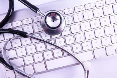 Directly above shot of stethoscope on keyboard