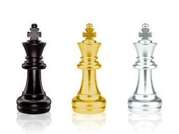 Low angle view of chess pieces against white background