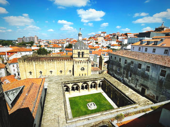 High angle view of buildings in town against sky