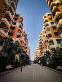 Street amidst buildings in city against sky