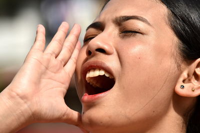 Close-up of woman shouting outdoors