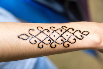 Cropped hand with henna tattoo