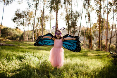 Young girl in dress up posing in field