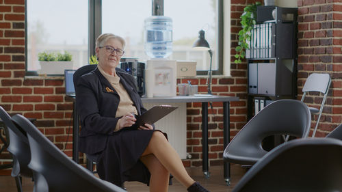 Portrait of young woman using laptop while sitting in cafe