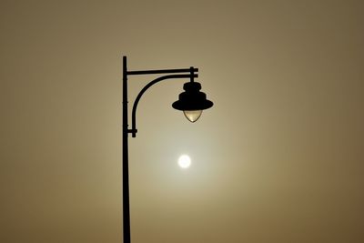 Low angle view of street light against sky during sunset