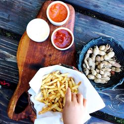 Directly above shot of hand holding food on table