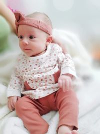 Cute baby girl lying on bed