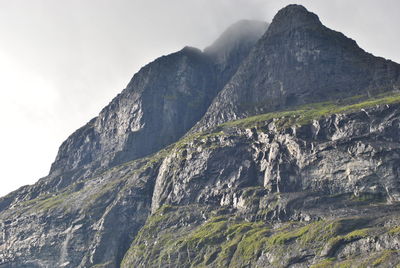 Low angle view of rocky mountains against sky