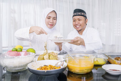 Portrait of a smiling young man preparing food
