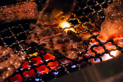 Close-up of meat cooking in barbecue grill