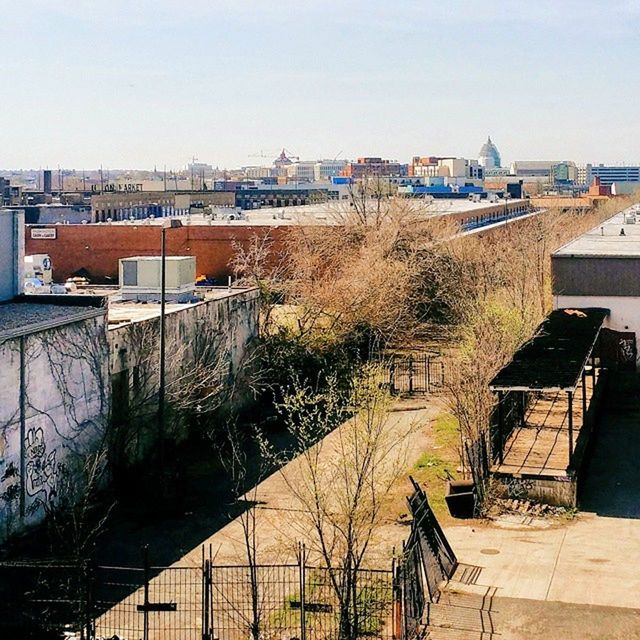 architecture, building exterior, built structure, house, residential building, residential structure, clear sky, railing, residential district, town, roof, water, city, building, tree, high angle view, sky, day, outdoors, no people