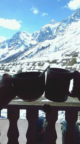 mountain, cold temperature, mountain range, winter, snow, lifestyles, leisure activity, sky, men, sitting, landscape, tranquility, day, relaxation, tranquil scene, season, nature, shoe