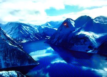 Scenic view of snow covered mountains against sky