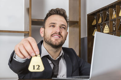 Portrait of smiling man using mobile phone