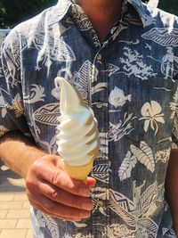 Midsection of man holding ice cream