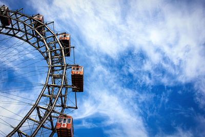 Low angle view of cropped ferris wheel against sky