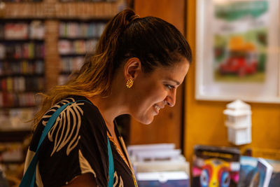 Side view of young woman using mobile phone