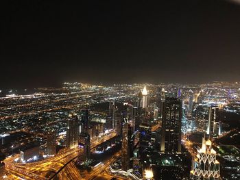 High angle view of illuminated cityscape against sky at night