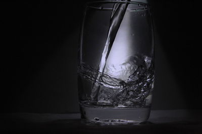 Close-up of glass over black background