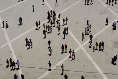 High angle view of people walking on road in city