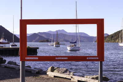 Sailboats in sea against clear sky