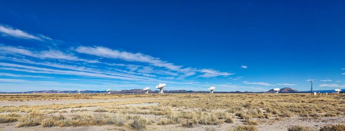 Scenic view of field against blue sky