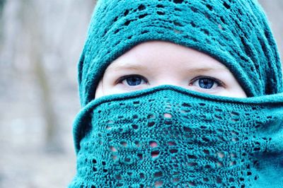 Close-up portrait of woman wearing blue scarf