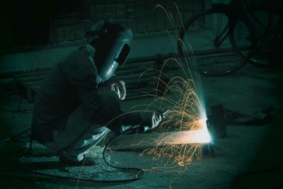 Welder welding metal in workshop