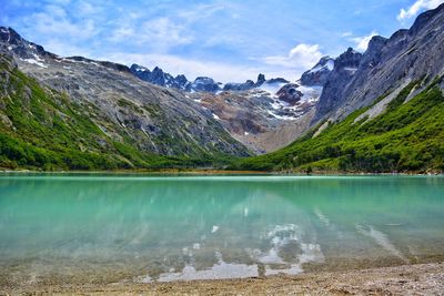 Scenic view of lake and mountains against sky