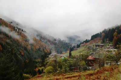 Scenic view of mountains against cloudy sky