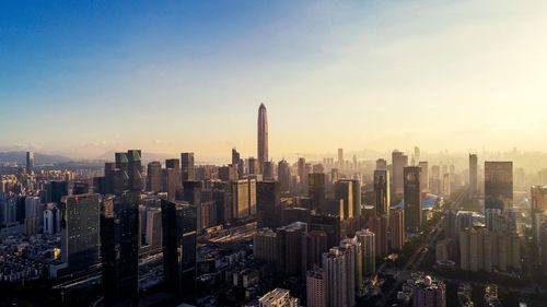 High angle view of city lit up at sunset