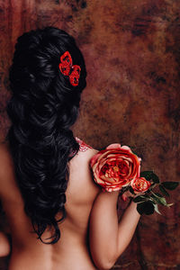 Close-up of woman with red roses