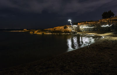 Scenic view of sea against sky at night