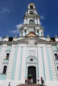 Low angle view of people outside building against sky