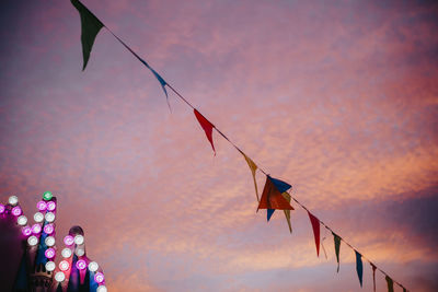 Low angle view of buntings hanging against sky during sunset