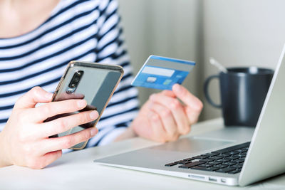 Midsection of man using mobile phone