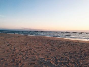 Scenic view of sea against clear sky during sunset