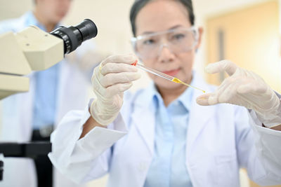 Dentist holding dentures in laboratory