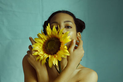 Portrait of beautiful young woman against gray background