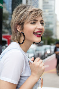 Portrait of a smiling young woman in city