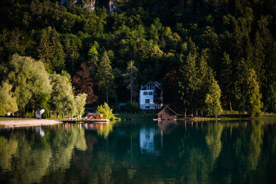 Scenic view of lake by trees and buildings