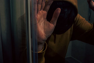 Midsection of man standing on glass