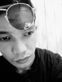 Close-up portrait of young man wearing sunglasses