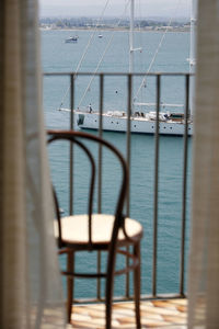 Sailboat sailing on sea against sky seen through window